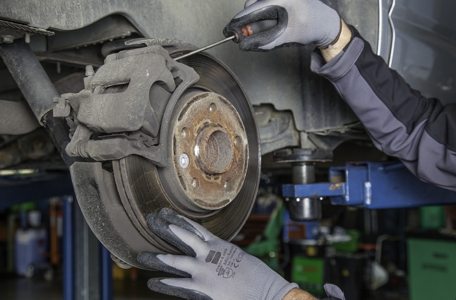 mechanic repairing brakes