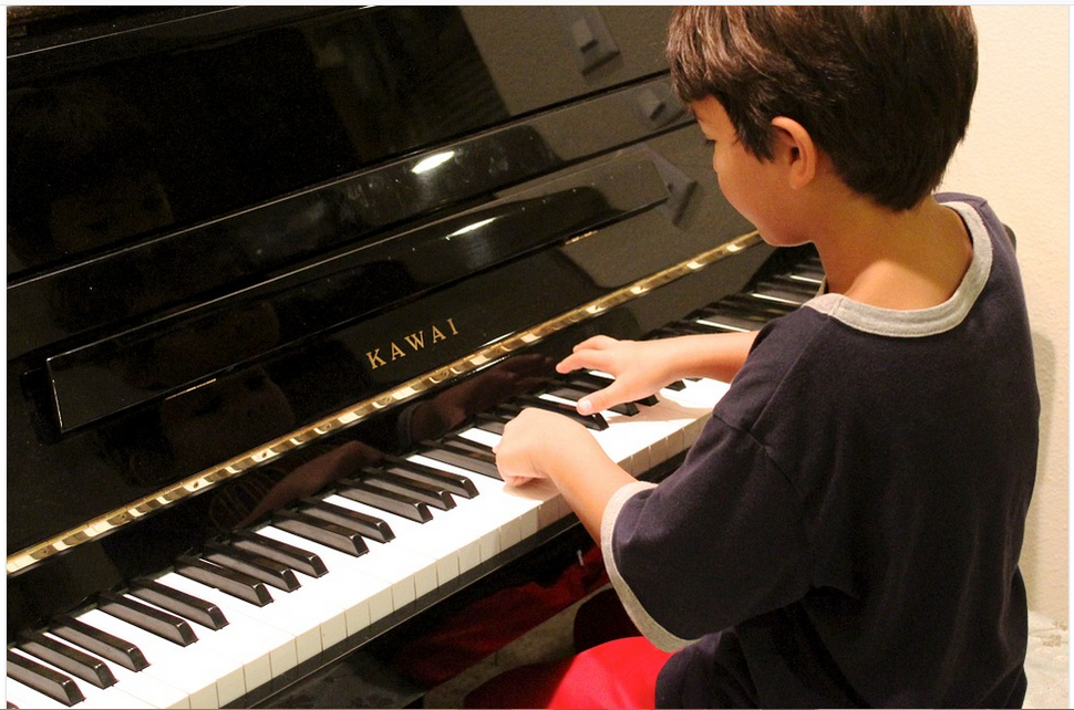 a boy playing the piano